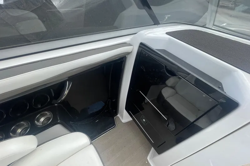 Slide: The Image of Interior view of a 2015 Yamaha Boats 242 Limited S, featuring sleek seating and storage. - 11