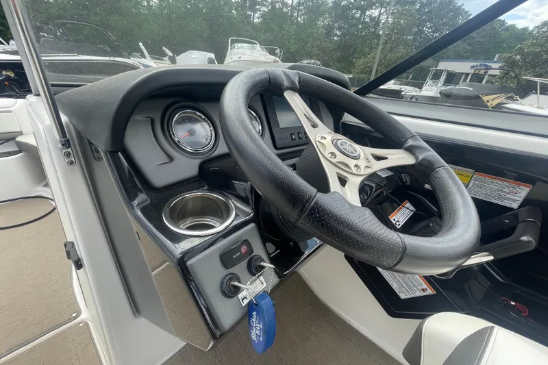 Slide: The Image of 2015 Yamaha Boats 242 Limited S dashboard with steering wheel and controls. - 13