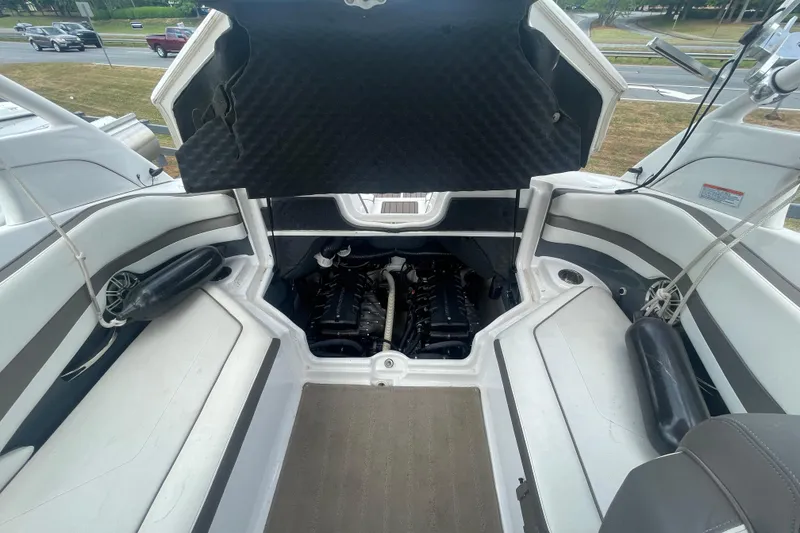 Slide: The Image of 2015 Yamaha Boats 242 Limited S engine compartment with open hatch, showcasing dual engines. - 17