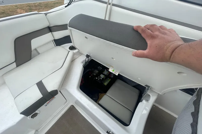Slide: The Image of 2015 Yamaha Boats 242 Limited S seat storage compartment open, revealing interior space. - 20