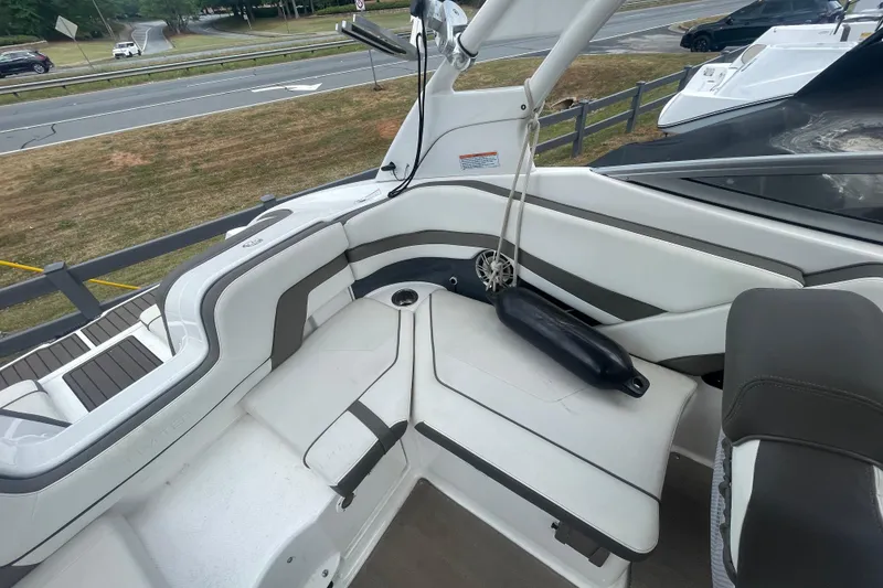 Slide: The Image of 2015 Yamaha Boats 242 Limited S interior with white seating and cup holder. - 21