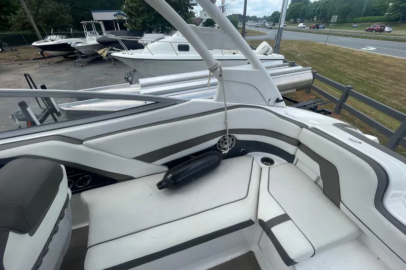 Slide: The Image of 2015 Yamaha Boats 242 Limited S interior with white seating and cup holders. - 22