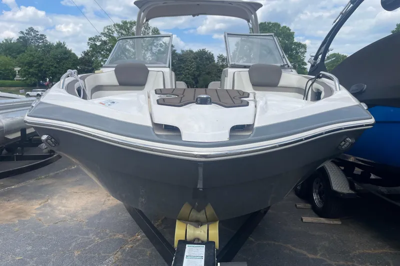 Slide: The Image of 2015 Yamaha Boats 242 Limited S on trailer, sleek design, parked outdoors. - 29