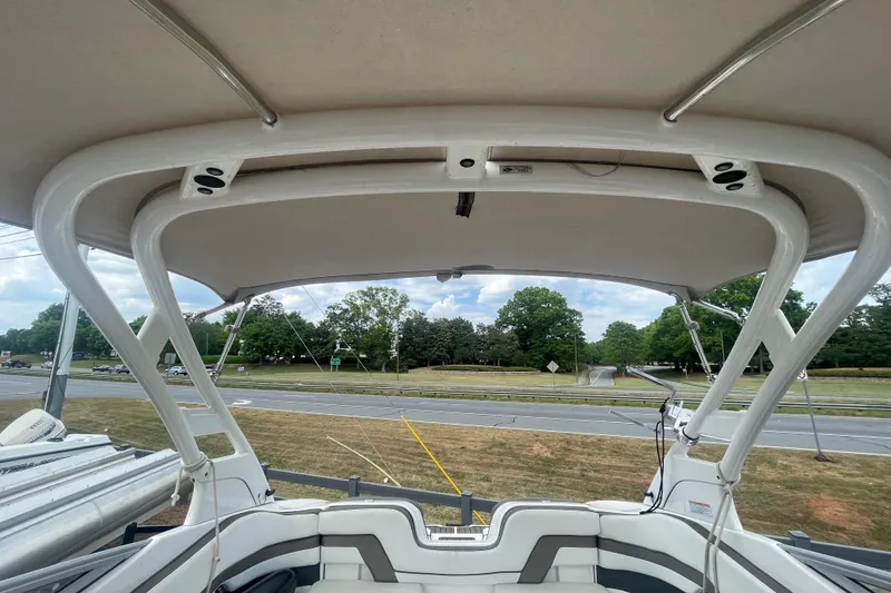 Slide: The Image of 2015 Yamaha Boats 242 Limited S interior view with canopy and seating. - 3