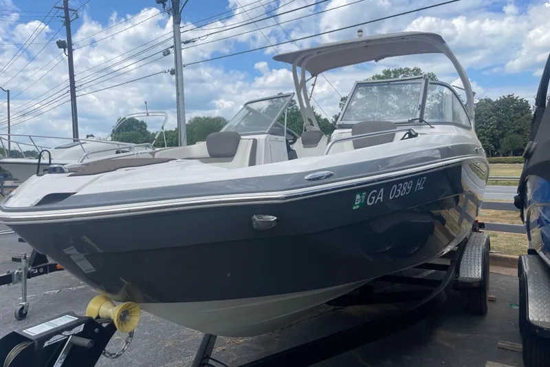 Slide: The Image of 2015 Yamaha Boats 242 Limited S on trailer, parked outdoors under a cloudy sky. - 30