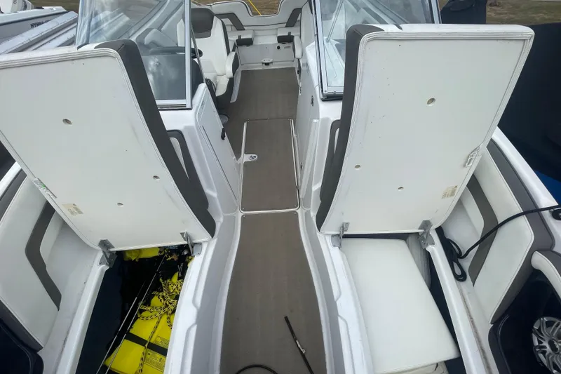 Slide: The Image of 2015 Yamaha Boats 242 Limited S interior with open storage compartments. - 7