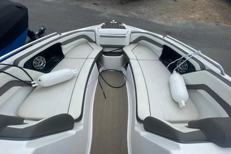 Slide: The Image of 2015 Yamaha Boats 242 Limited S interior with white seating and cup holders. - 8