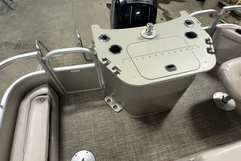 Slide: The Image of 2014 Bennington 22 SSX boat interior with seating, console, and Mercury engine. - 12