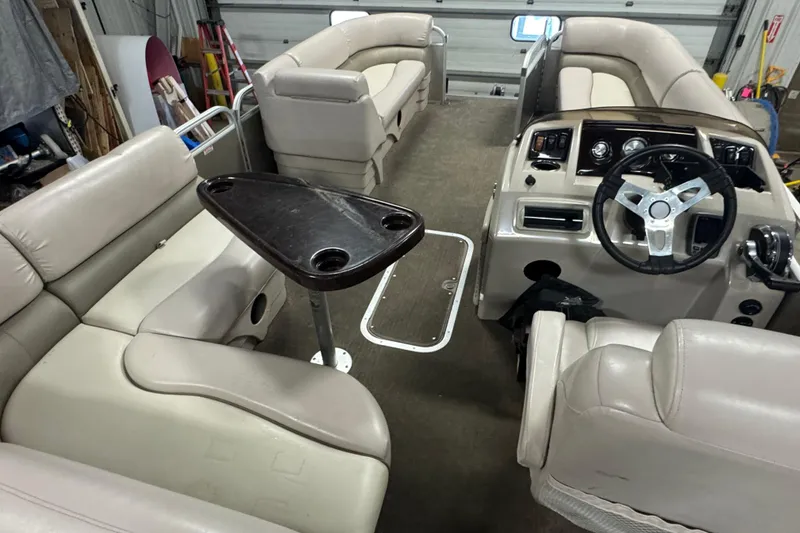 Slide: The Image of 2014 Bennington 22 SSX boat interior with beige seating and steering console. - 15