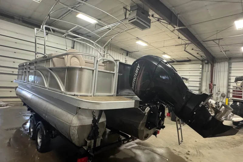 Slide: The Image of 2014 Bennington 22 SSX pontoon boat with Mercury outboard motor in a garage. - 4
