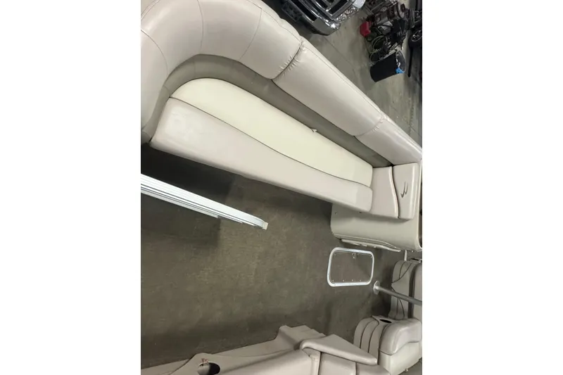 Slide: The Image of 2014 Bennington 22 SSX boat interior with beige seating and metal railing. - 5