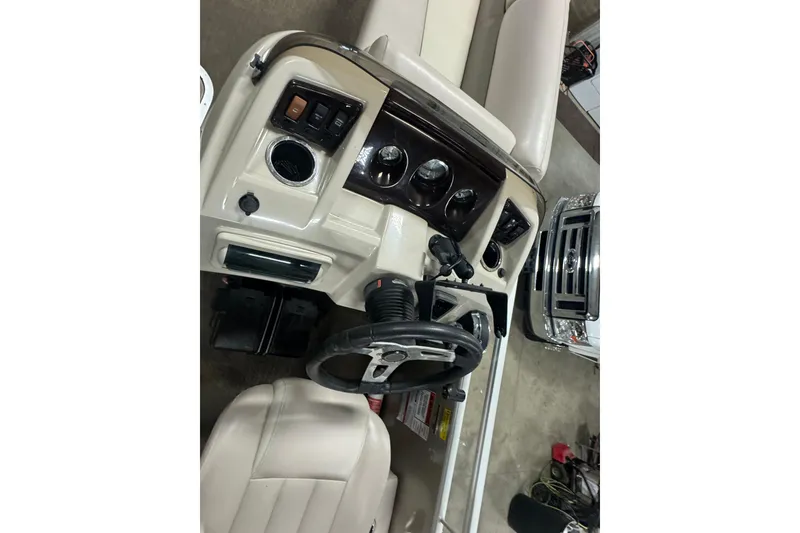 Slide: The Image of 2014 Bennington 22 SSX boat dashboard with steering wheel and control panel. - 8