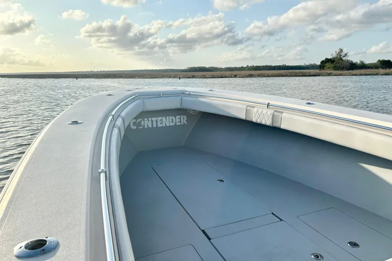 Slide: The Image of 2006 Contender 33 Tournament boat on calm water under a partly cloudy sky. - 14
