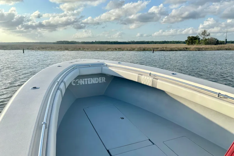 Slide: The Image of 2006 Contender 33 Tournament boat on calm water with scenic marshland background. - 15