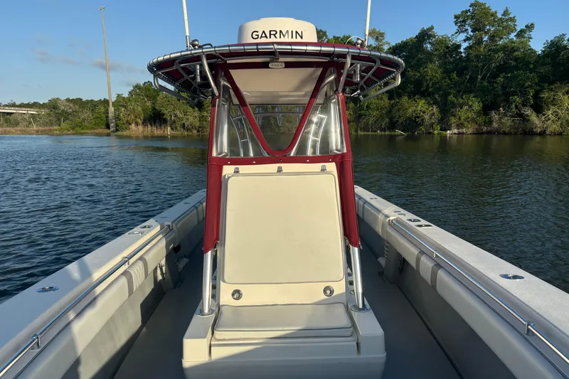 Slide: The Image of 2006 Contender 33 Tournament boat on calm water, featuring Garmin equipment. - 18