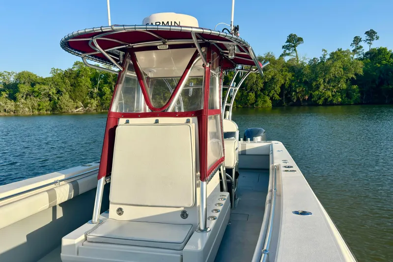 Slide: The Image of 2006 Contender 33 Tournament boat on calm water with lush green shoreline. - 19
