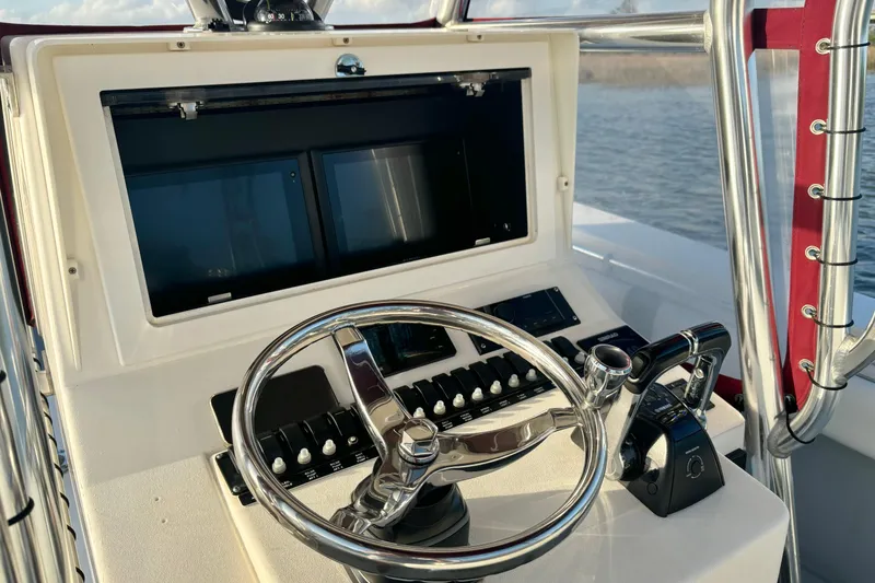 Slide: The Image of Helm of 2006 Contender 33 Tournament boat with steering wheel and controls. - 23