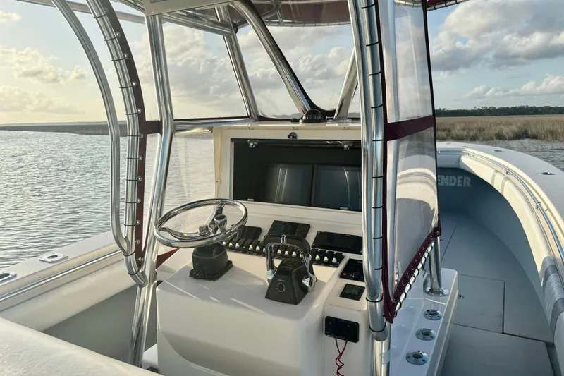 Slide: The Image of 2006 Contender 33 Tournament boat cockpit with steering wheel, controls, and open water view. - 25