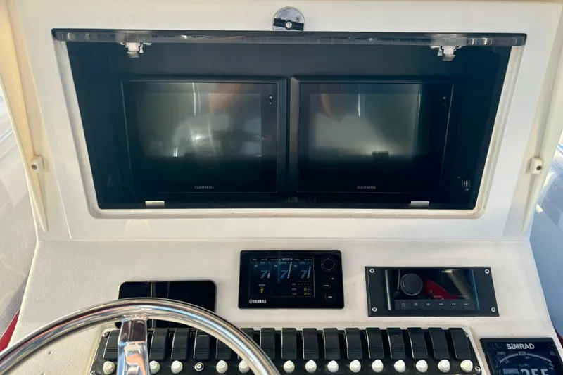 Slide: The Image of Dashboard of a 2006 Contender 33 Tournament boat with Garmin displays and controls. - 27