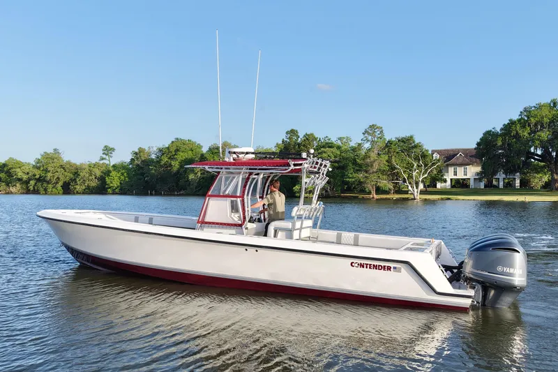 Slide: The Image of 2006 Contender 33 Tournament boat on a serene lake with lush greenery. - 3
