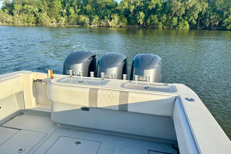 Slide: The Image of 2006 Contender 33 Tournament boat with triple engines on a calm river. - 31