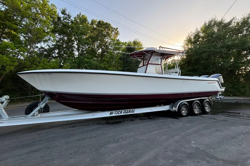 Slide: The Image of 2006 Contender 33 Tournament boat on trailer, surrounded by trees, at sunset. - 32