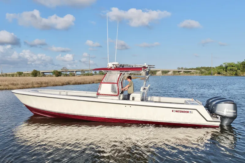 Slide: The Image of 2006 Contender 33 Tournament boat on calm water with Yamaha engines. - 4