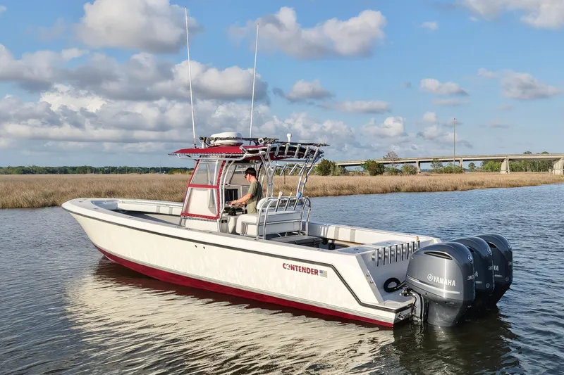 Slide: The Image of 2006 Contender 33 Tournament boat on water with triple Yamaha engines. - 5