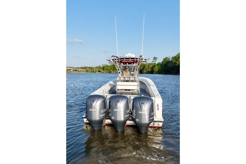 Slide: The Image of 2006 Contender 33 Tournament boat with triple 300 horsepower engines on a calm river. - 8