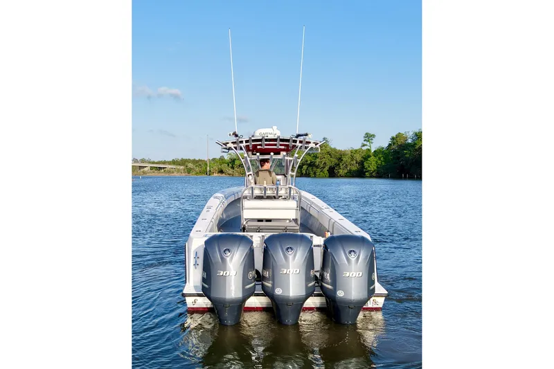 Slide: The Image of 2006 Contender 33 Tournament boat with triple 300 horsepower engines on a calm river. - 9