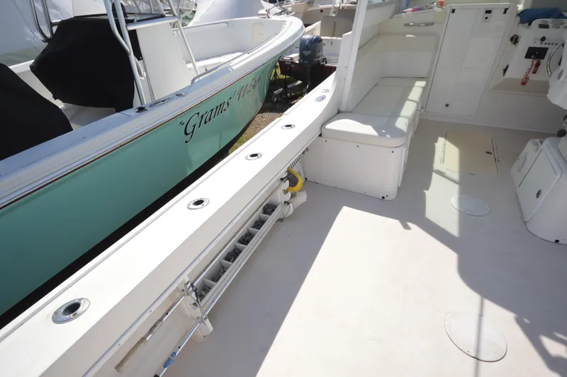 Slide: The Image of 2009 Steiger Craft 26 Miami boat interior with seating and storage compartments. - 12