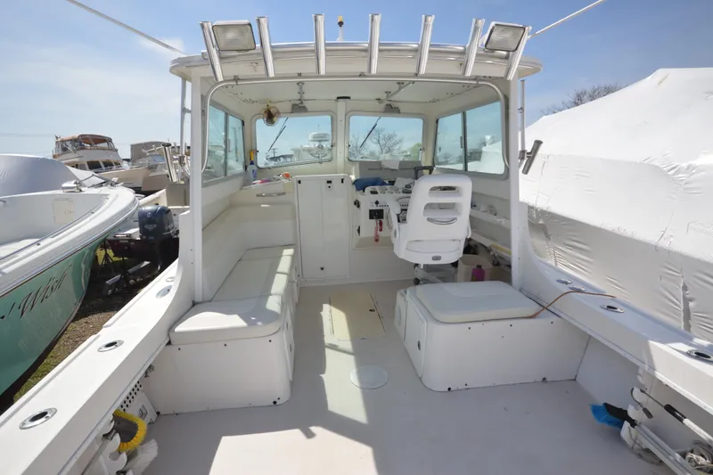 Slide: The Image of 2009 Steiger Craft 26 Miami boat interior with seating and helm station. - 13