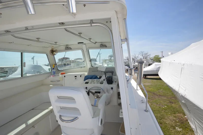 Slide: The Image of 2009 Steiger Craft 26 Miami boat interior with helm and seating area. - 15