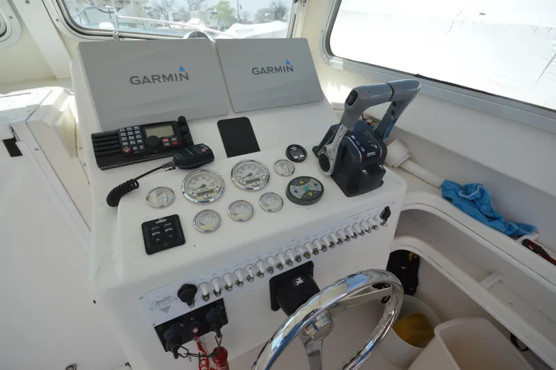 Slide: The Image of 2009 Steiger Craft 26 Miami boat dashboard with Garmin navigation and control instruments. - 17