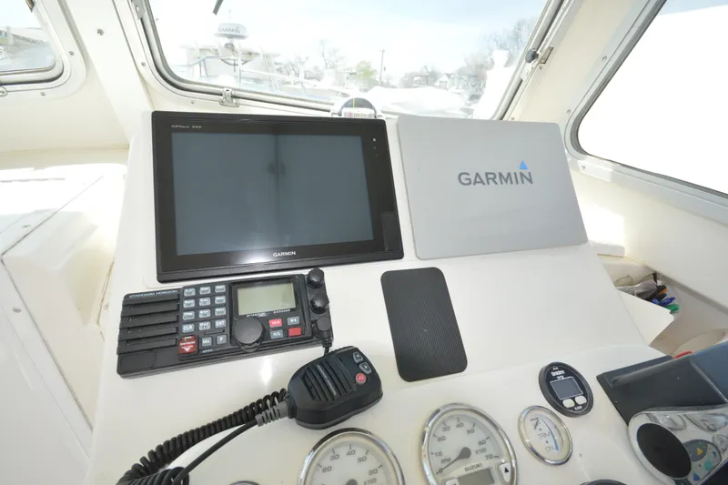Slide: The Image of 2009 Steiger Craft 26 Miami boat dashboard with Garmin navigation system and communication equipment. - 18