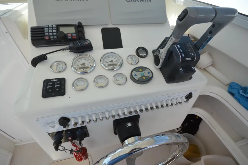 Slide: The Image of Control panel of a 2009 Steiger Craft 26 Miami boat with gauges and navigation equipment. - 19