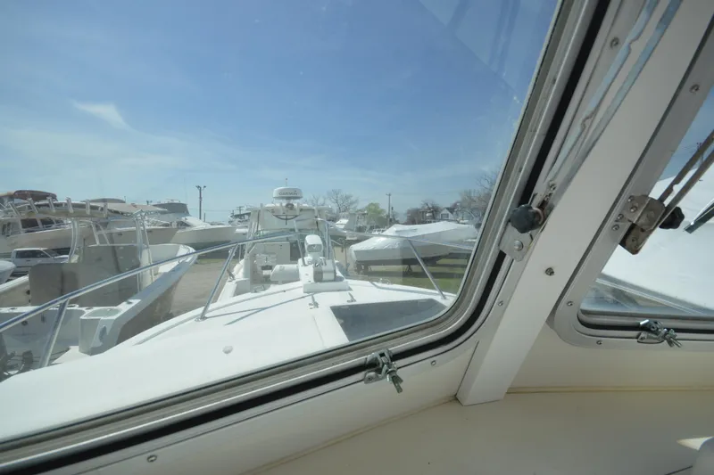 Slide: The Image of View from inside a 2009 Steiger Craft 26 Miami boat, showcasing the deck and marina. - 23