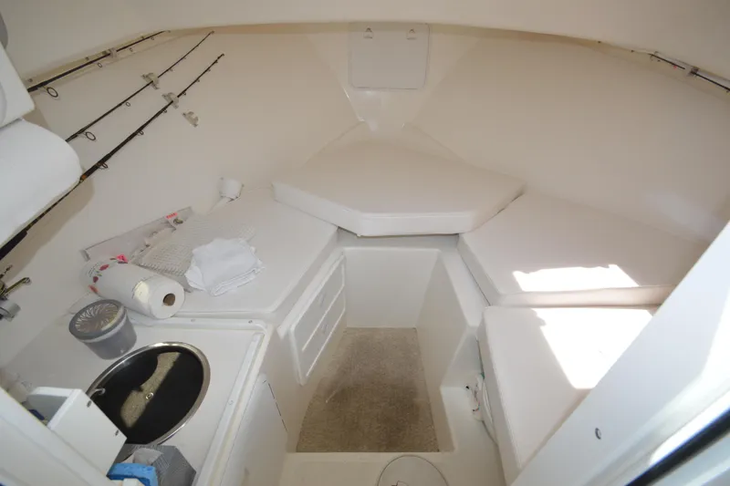 Slide: The Image of Interior cabin of 2009 Steiger Craft 26 Miami boat with seating and storage. - 25