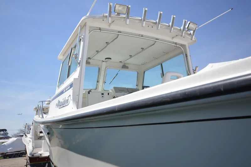 Slide: The Image of 2009 Steiger Craft 26 Miami boat with cabin, viewed from below against blue sky. - 29