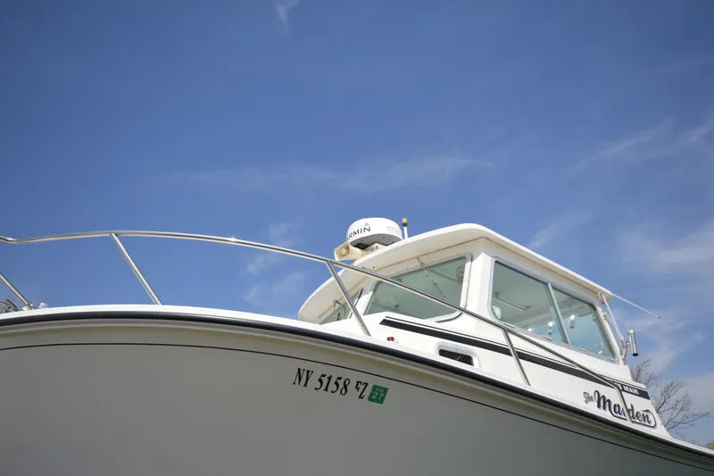 Slide: The Image of 2009 Steiger Craft 26 Miami boat against a clear blue sky. - 4