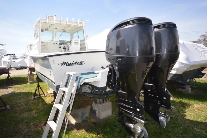 Slide: The Image of 2009 Steiger Craft 26 Miami boat with twin outboard engines on display. - 6