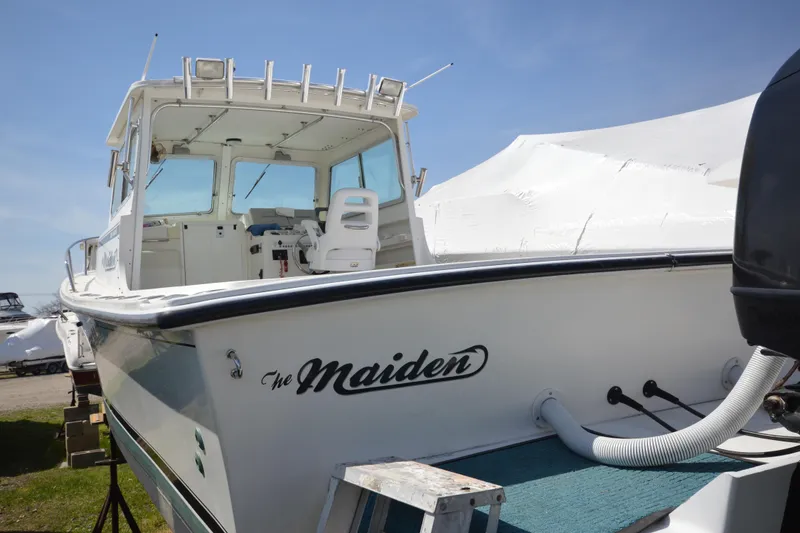Slide: The Image of 2009 Steiger Craft 26 Miami boat named "The Maiden" on display outdoors. - 7