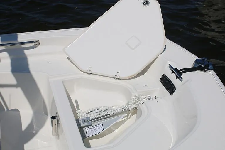 Slide: The Image of Manufacturer Provided Image: 2026 Boston Whaler 150 Montauk boat anchor storage compartment with open hatch. - 12