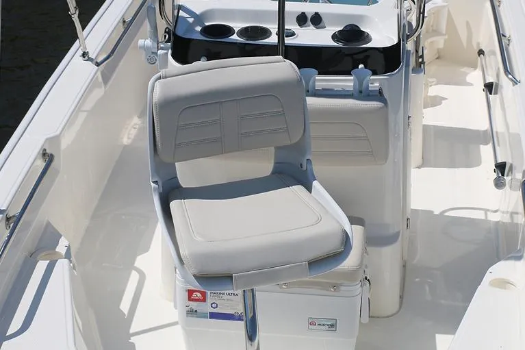 Slide: The Image of Manufacturer Provided Image: 2026 Boston Whaler 150 Montauk boat interior with cushioned seating and control panel. - 15