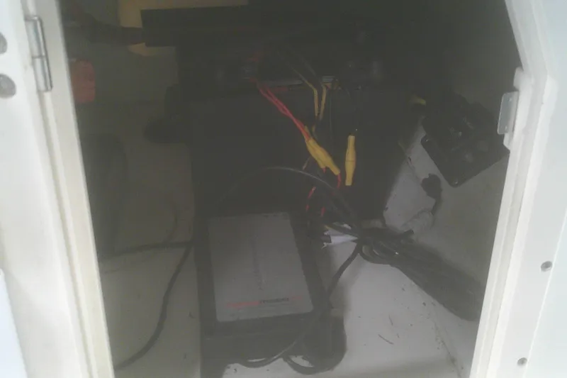 Slide: The Image of Interior view of a 2012 Boston Whaler 150 Montauk boat's electrical compartment. - 10