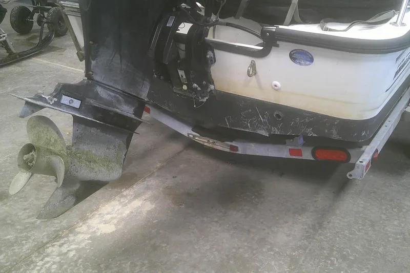 Slide: The Image of 2012 Boston Whaler 150 Montauk boat with visible wear on the propeller and hull. - 14