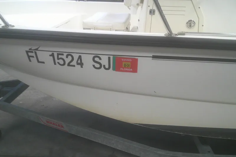 Slide: The Image of 2012 Boston Whaler 150 Montauk boat with Florida registration on trailer. - 17