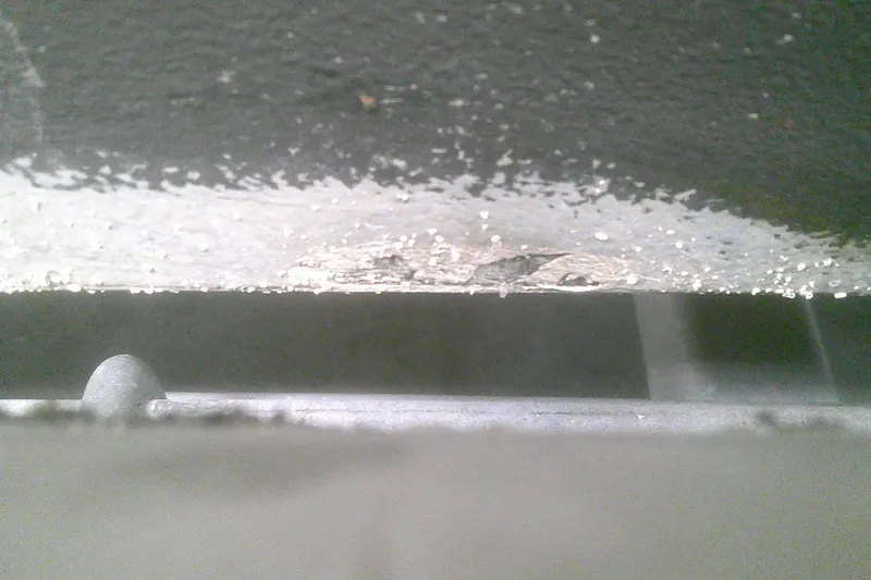 Slide: The Image of Close-up of a 2012 Boston Whaler 150 Montauk hull with visible paint damage. - 21