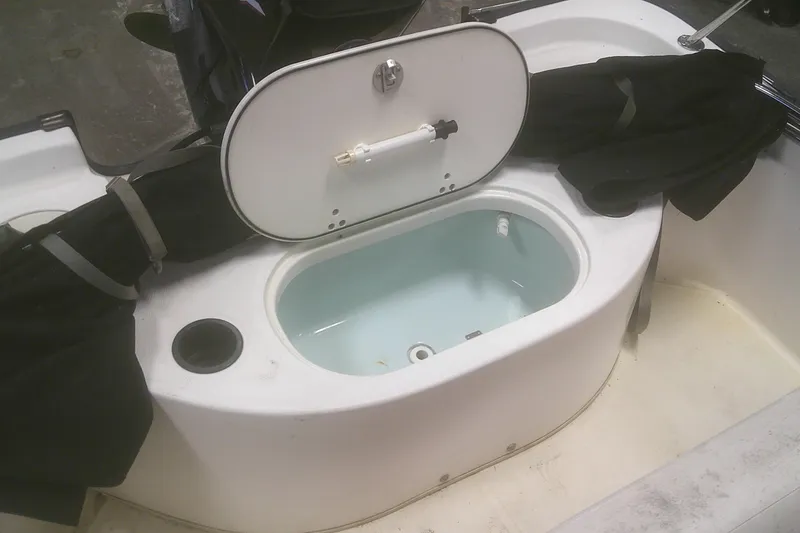Slide: The Image of Open storage compartment on a 2012 Boston Whaler 150 Montauk boat. - 4