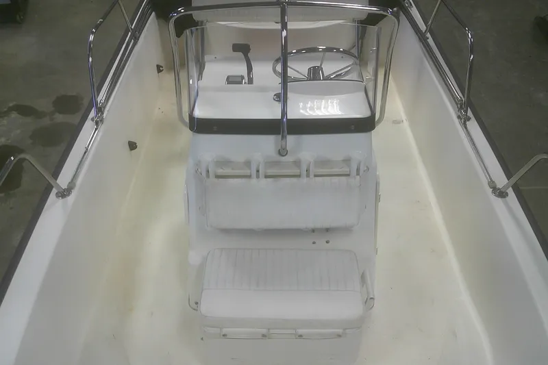 Slide: The Image of 2012 Boston Whaler 150 Montauk interior with steering console and seating. - 7